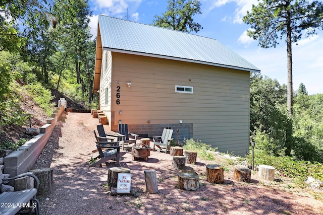 rear view of house with a fire pit