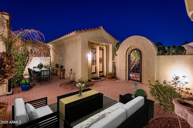 patio at twilight featuring an outdoor hangout area