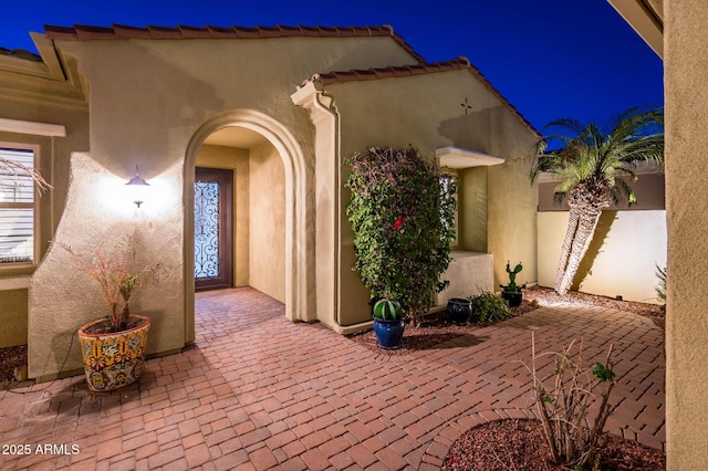 doorway to property with a patio area