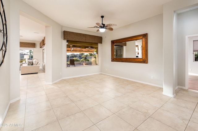 spare room with light tile patterned floors, plenty of natural light, and ceiling fan