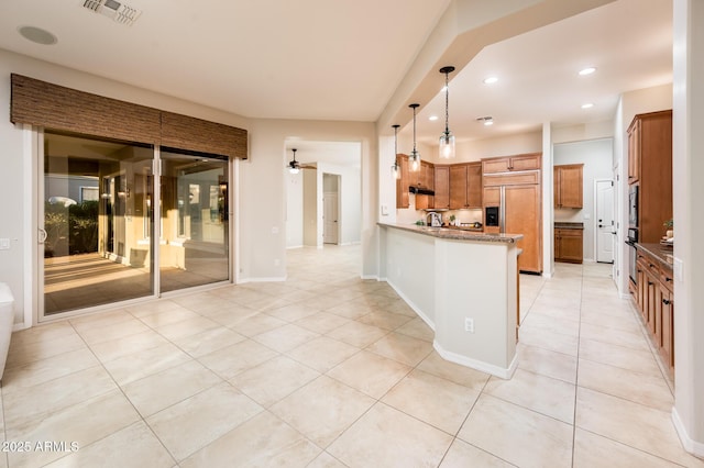 kitchen featuring hanging light fixtures, built in appliances, ceiling fan, light tile patterned flooring, and kitchen peninsula