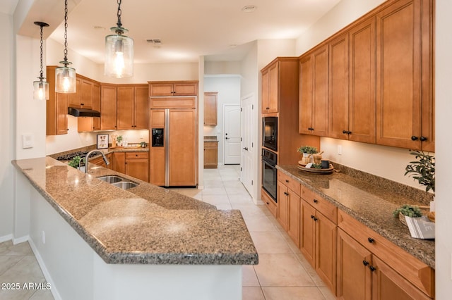 kitchen with kitchen peninsula, sink, black appliances, pendant lighting, and light tile patterned floors