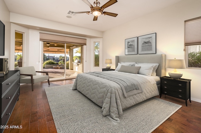 bedroom with access to exterior, ceiling fan, multiple windows, and dark hardwood / wood-style floors