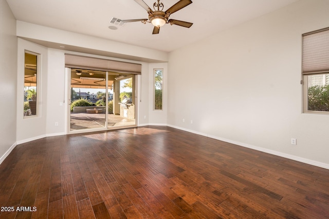 spare room featuring a wealth of natural light, ceiling fan, and hardwood / wood-style floors