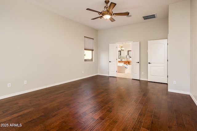 spare room with ceiling fan and dark hardwood / wood-style flooring