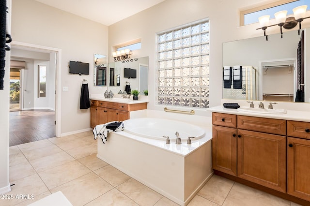 bathroom featuring tile patterned flooring, vanity, and a healthy amount of sunlight