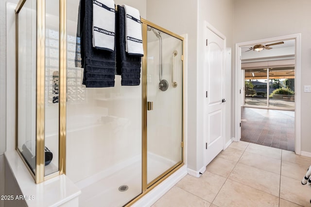 bathroom featuring tile patterned floors, a shower with door, and ceiling fan