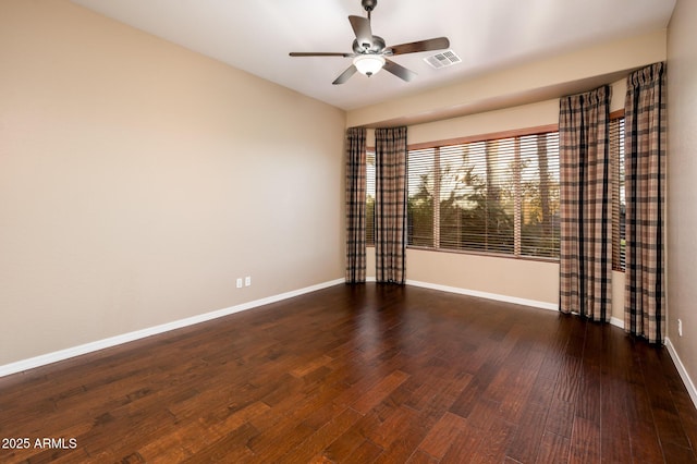 empty room with ceiling fan and dark hardwood / wood-style floors