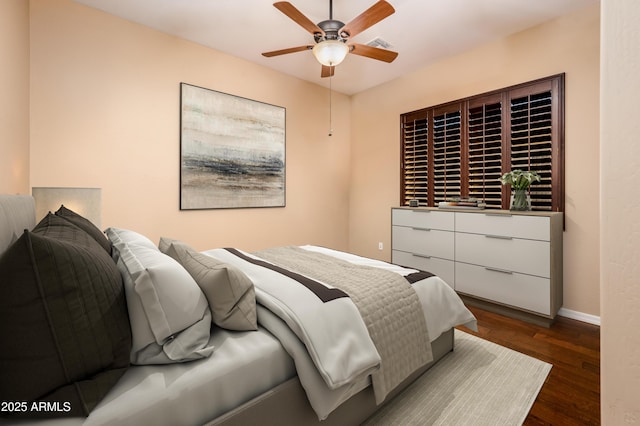 bedroom with ceiling fan and dark hardwood / wood-style floors