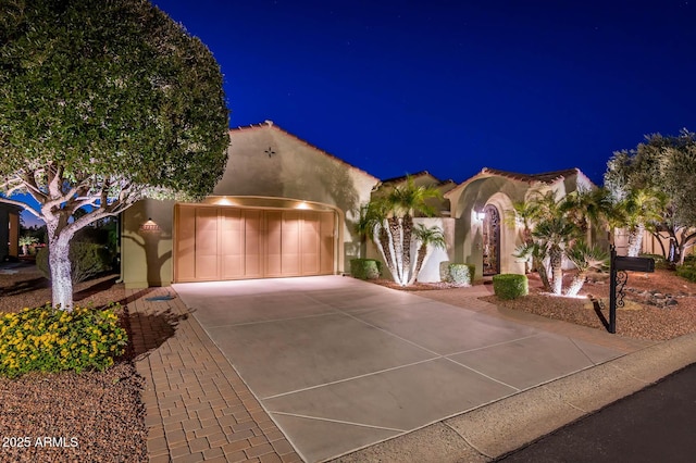 mediterranean / spanish-style home with a garage