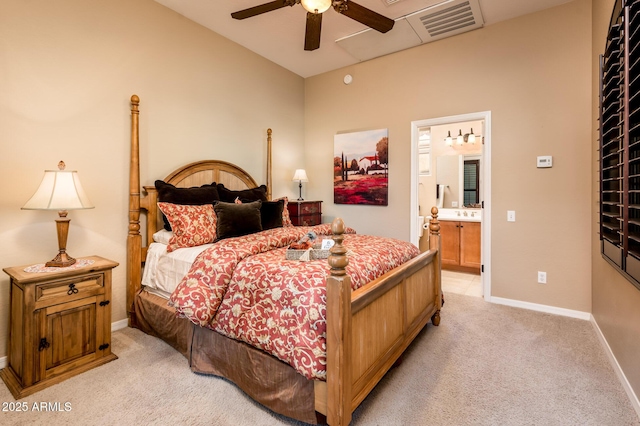 carpeted bedroom with ceiling fan and ensuite bath