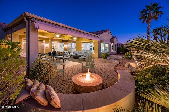 view of patio / terrace featuring an outdoor living space with a fire pit