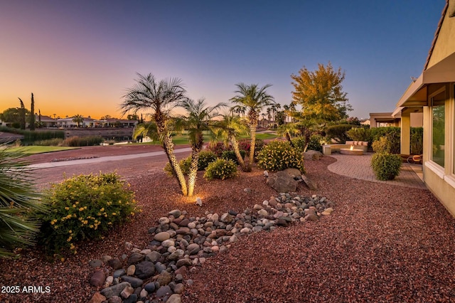 yard at dusk with a patio area