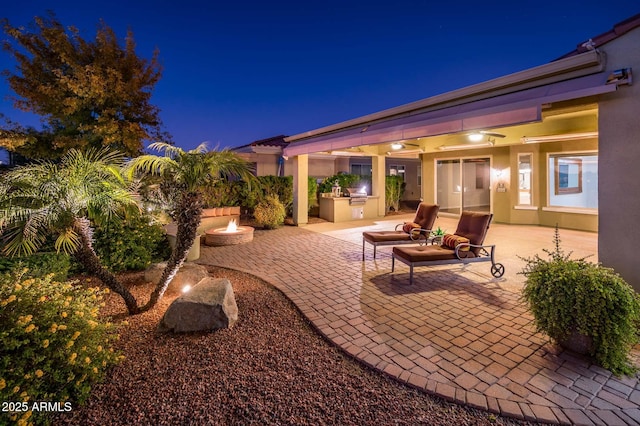 patio at twilight with exterior kitchen