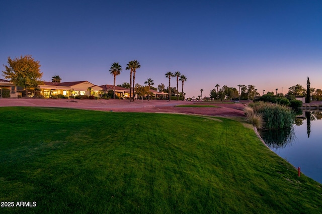 yard at dusk with a water view