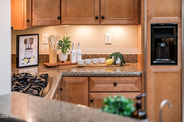 kitchen with stone countertops and stainless steel gas cooktop