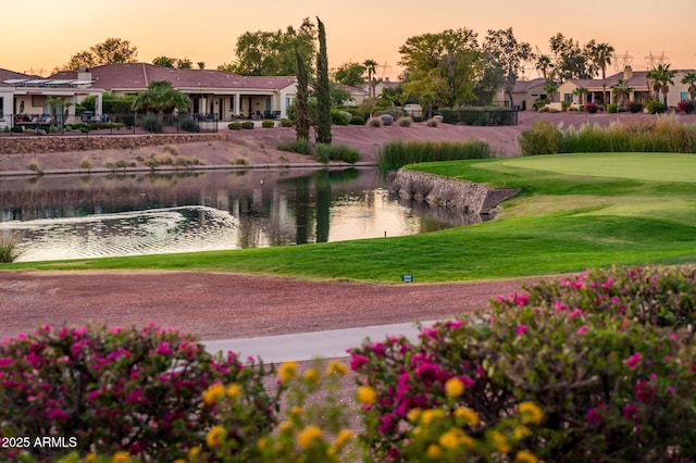 view of property's community with a yard and a water view