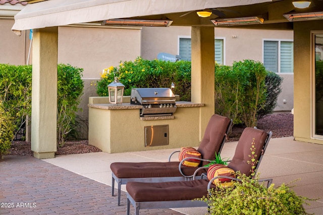 view of patio with an outdoor kitchen and a grill