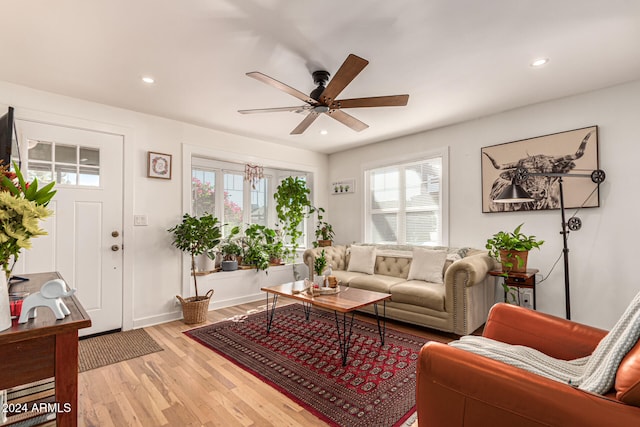 living room with light hardwood / wood-style floors and ceiling fan