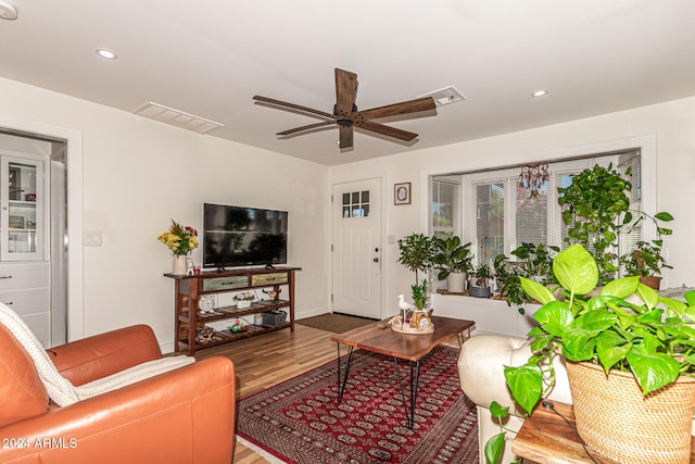 living room featuring wood-type flooring and ceiling fan