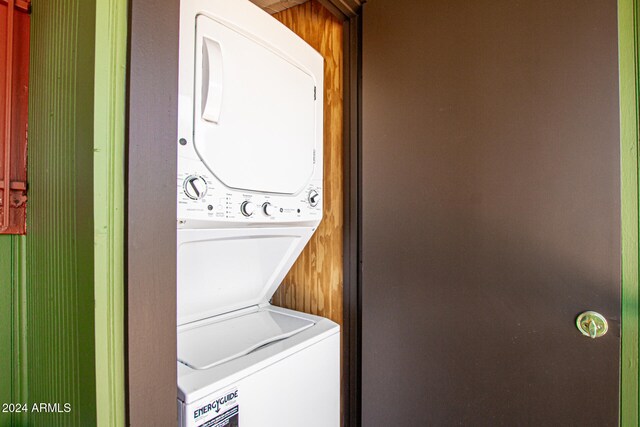 laundry area featuring stacked washer / dryer