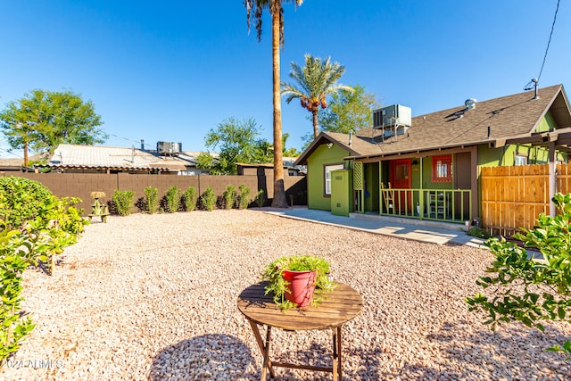 view of yard with central air condition unit and a patio