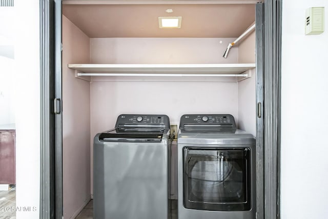 washroom with washing machine and dryer