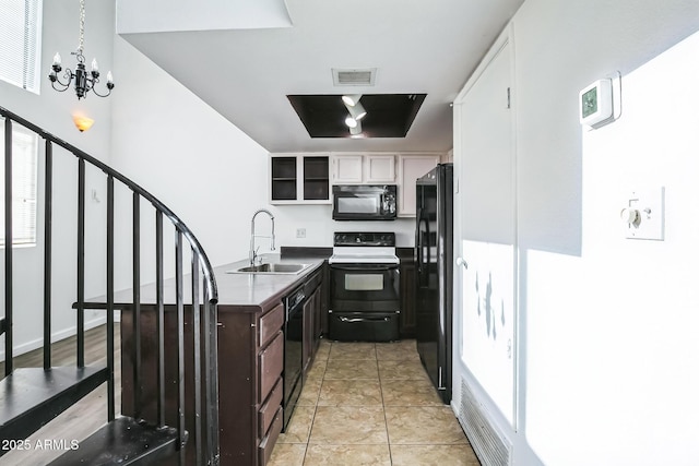 kitchen featuring black appliances, sink, light tile patterned floors, a notable chandelier, and dark brown cabinetry