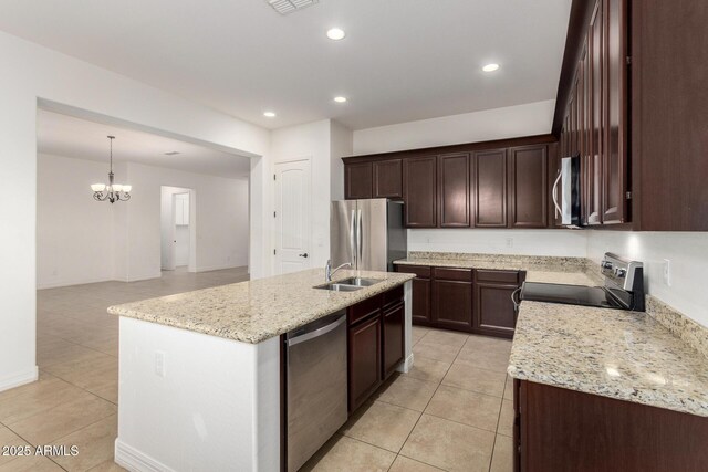 4571 N Arbor Way, Buckeye, AZ 85396 - kitchen with stainless steel appliances, light tile patterned floors, a chandelier, a kitchen island with sink, and a sink