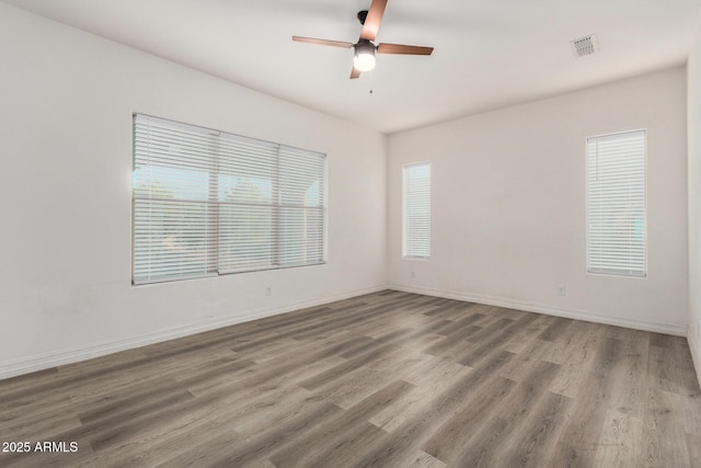 4571 N Arbor Way, Buckeye, AZ 85396 - empty room with wood finished floors, ceiling fan, and baseboards