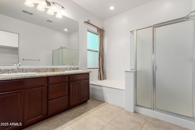 4571 N Arbor Way, Buckeye, AZ 85396 - bathroom featuring a shower stall, double vanity, a garden tub, and tile patterned flooring