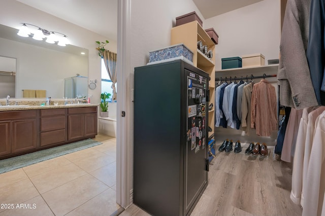 4571 N Arbor Way, Buckeye, AZ 85396 - spacious closet featuring a sink and light tile patterned floors