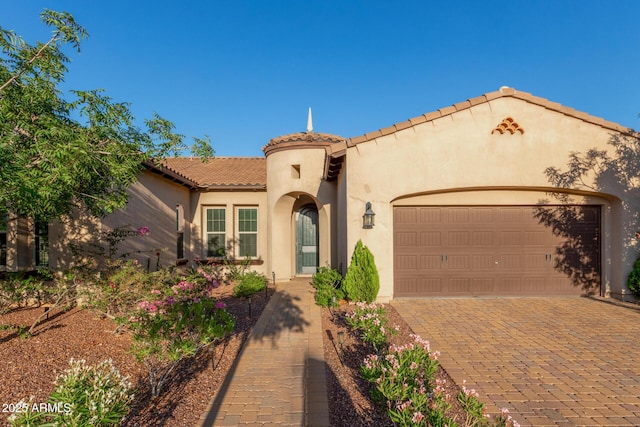 4571 N Arbor Way, Buckeye, AZ 85396 - mediterranean / spanish home with stucco siding, a tile roof, an attached garage, and decorative driveway