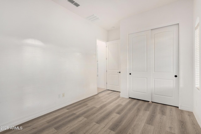 4571 N Arbor Way, Buckeye, AZ 85396 - unfurnished bedroom with wood finished floors, a closet, and baseboards