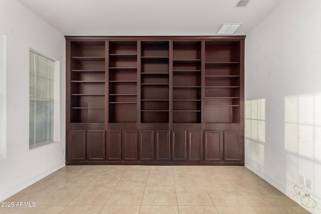 4571 N Arbor Way, Buckeye, AZ 85396 - spare room with built in features, light tile patterned flooring, and baseboards