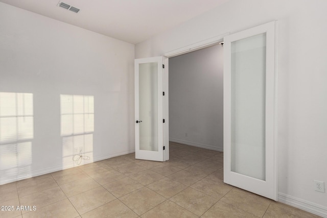 4571 N Arbor Way, Buckeye, AZ 85396 - unfurnished room featuring french doors, light tile patterned floors, and baseboards