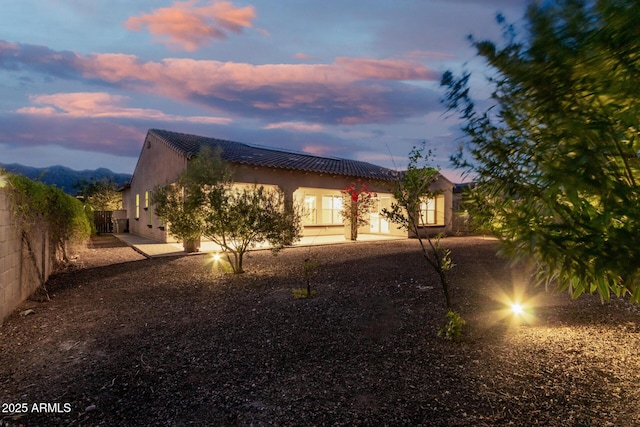 4571 N Arbor Way, Buckeye, AZ 85396 - rear view of property with stucco siding and a tile roof