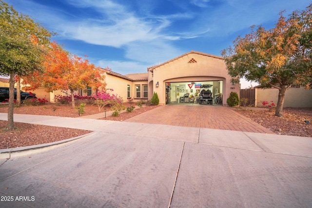 4571 N Arbor Way, Buckeye, AZ 85396 - mediterranean / spanish-style home featuring decorative driveway, a garage, stucco siding, and a tile roof