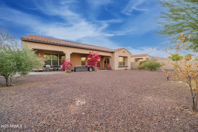 4571 N Arbor Way, Buckeye, AZ 85396 - rear view of property featuring stucco siding, a tiled roof, and a patio area