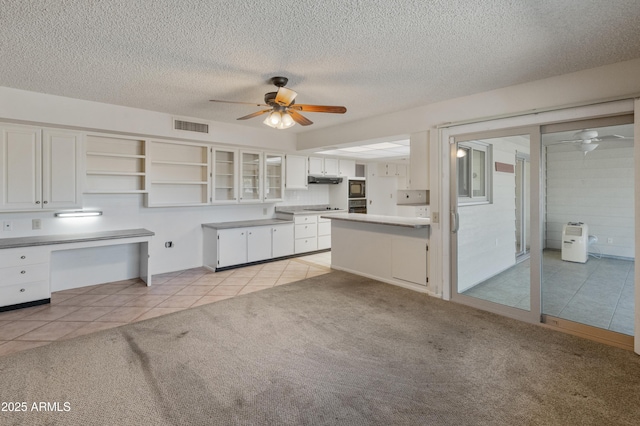 kitchen with ceiling fan, white cabinets, light colored carpet, tasteful backsplash, and black microwave