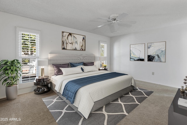 bedroom with ceiling fan, a textured ceiling, and carpet floors