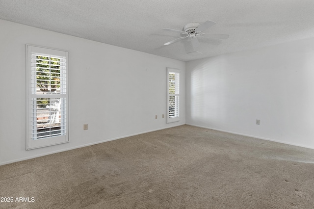 spare room with ceiling fan, a textured ceiling, and carpet flooring