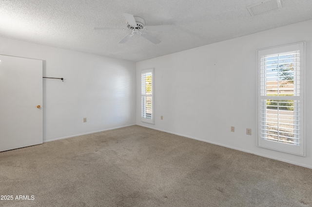 unfurnished room featuring ceiling fan, carpet, and a textured ceiling