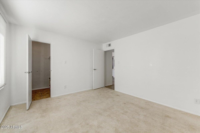 empty room with light colored carpet