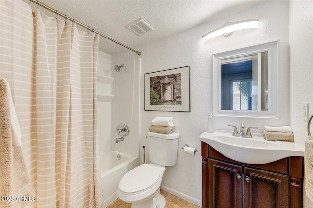 full bathroom featuring vanity, toilet, shower / bath combo with shower curtain, and a textured ceiling