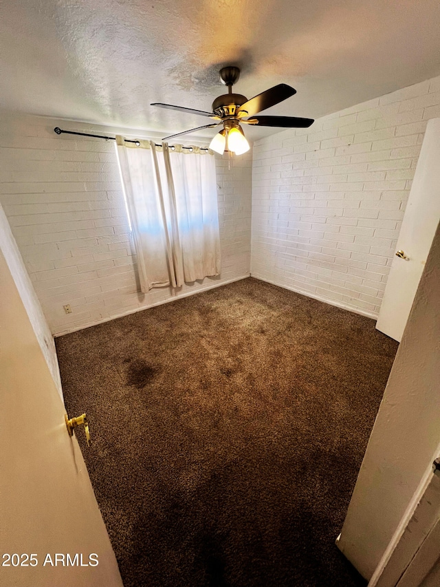 3905 W Almeria Rd, Phoenix, AZ 85009 - carpeted spare room with brick wall, a ceiling fan, and a textured ceiling