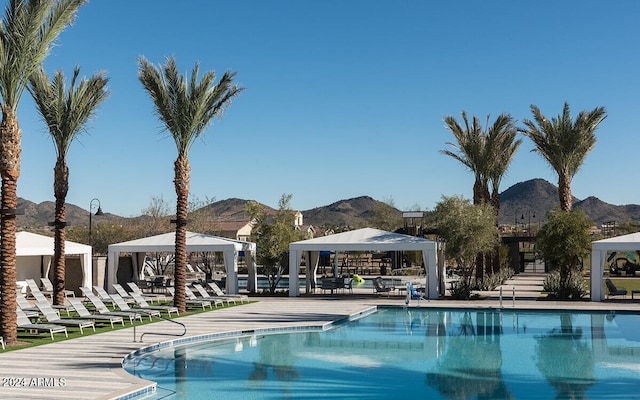 community pool with a mountain view, a gazebo, and a patio