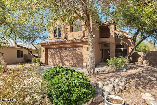 view of front of house with an attached garage and stucco siding