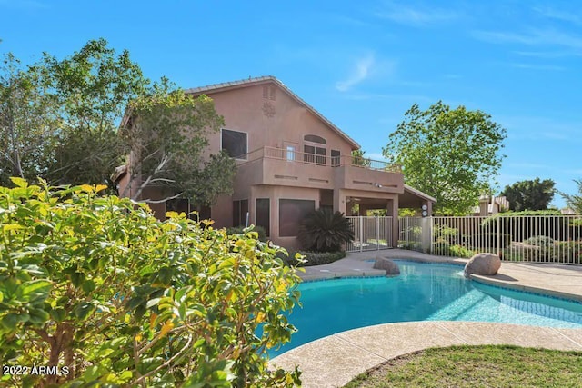 view of swimming pool featuring a fenced in pool, fence, and a patio area