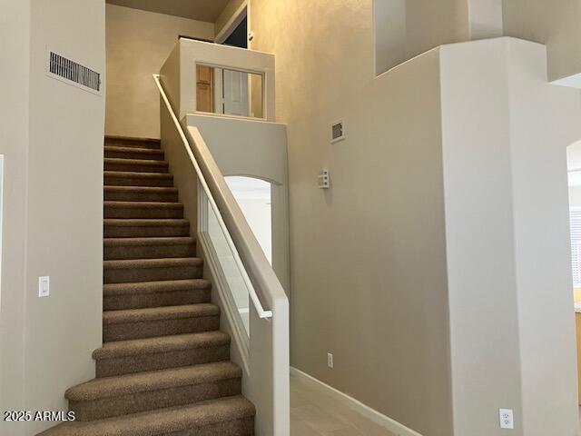 staircase featuring baseboards